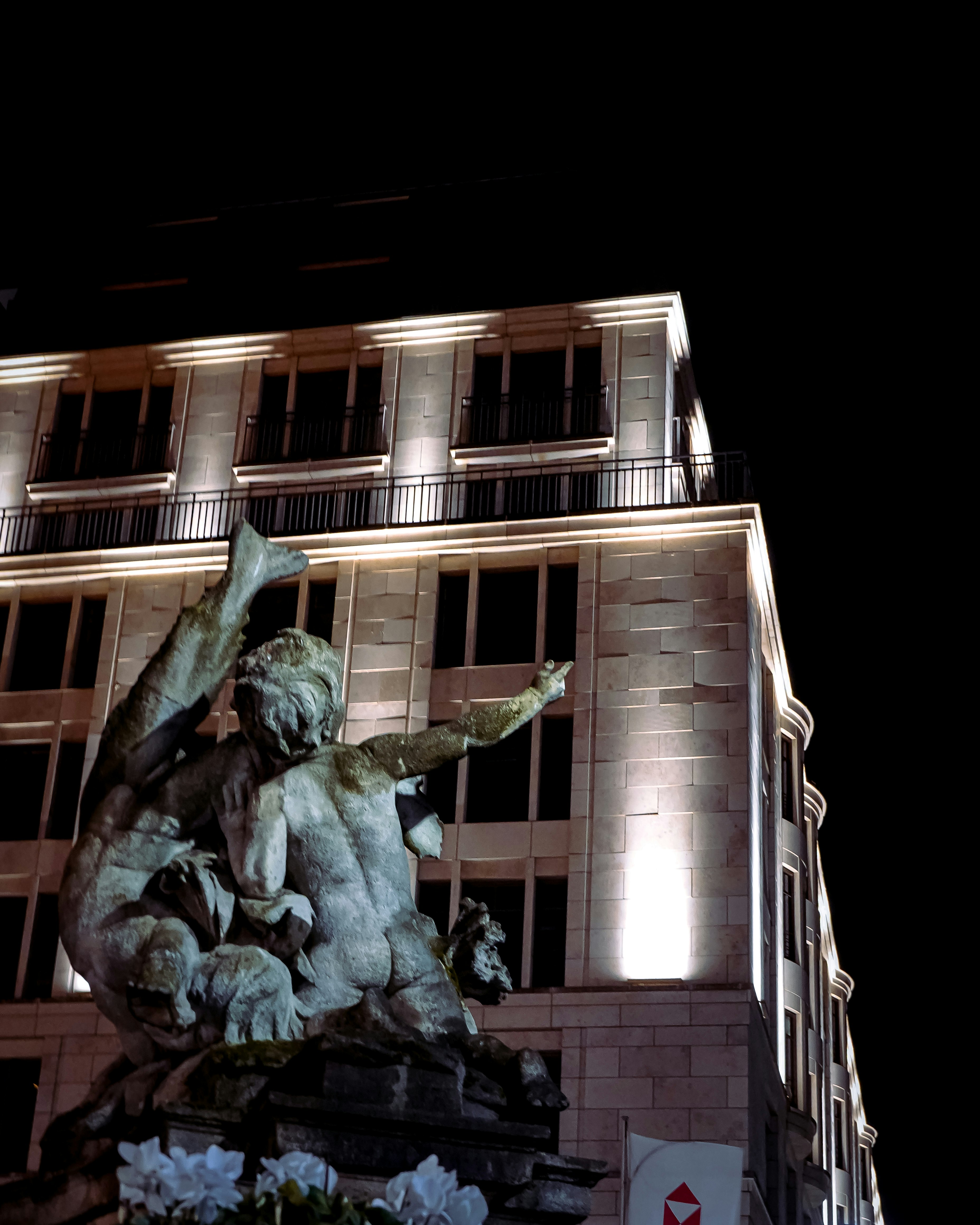 gray concrete building with green and brown dragon statue